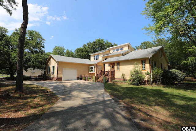 509 Telegraph Ct Lot 17, Kill Devil Hills, NC 27948 - split level home featuring a garage, driveway, a front lawn, and a shingled roof