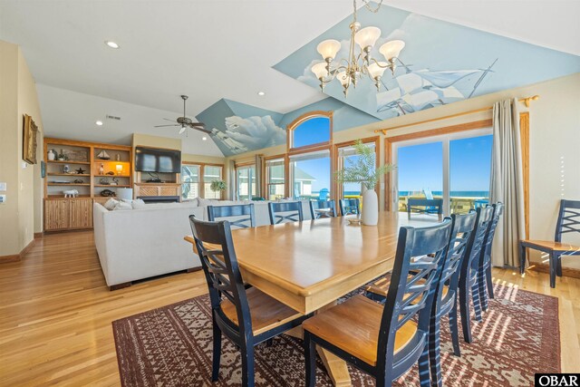 dining area featuring vaulted ceiling, ceiling fan with notable chandelier, light wood-type flooring, and recessed lighting