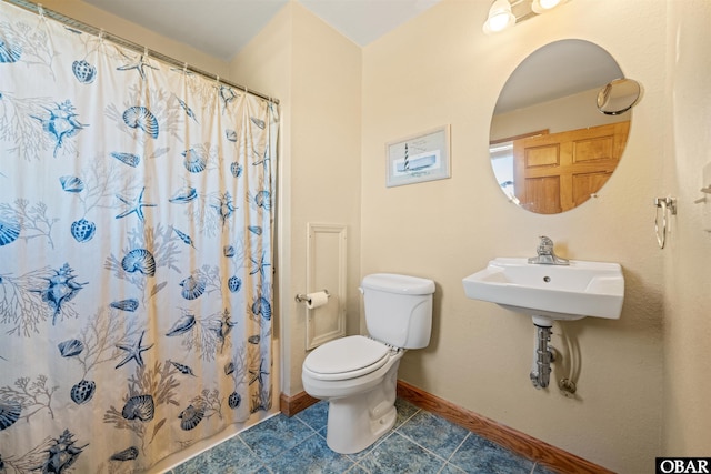 bathroom featuring a shower with curtain, toilet, baseboards, and tile patterned floors