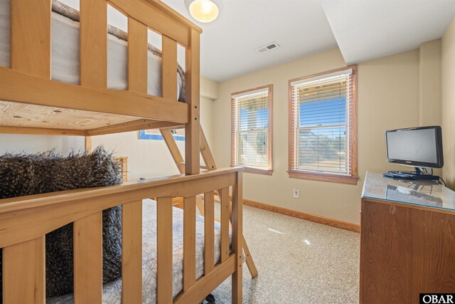 bedroom featuring baseboards and visible vents