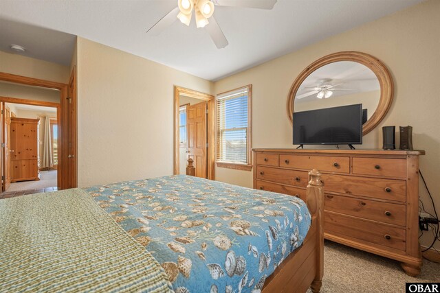 bedroom with a ceiling fan and light colored carpet