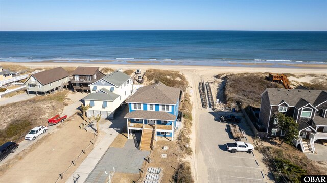 aerial view featuring a residential view, a water view, and a beach view