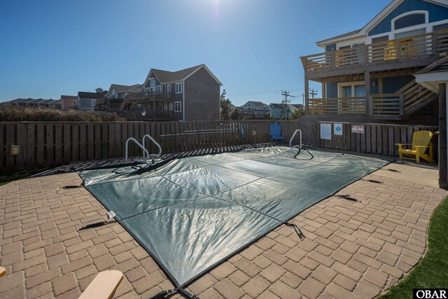 pool featuring a patio and fence