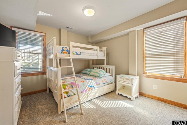 bedroom with light carpet, visible vents, and baseboards