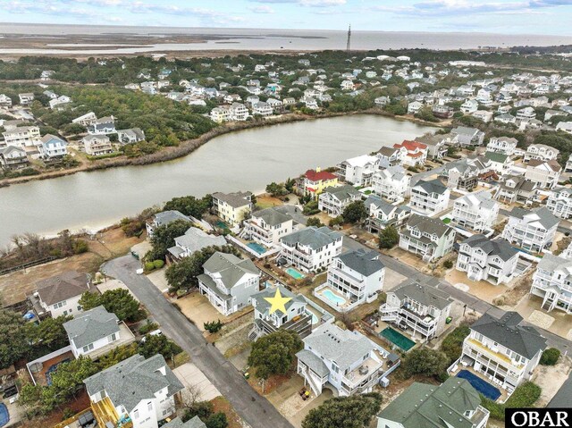 birds eye view of property featuring a water view and a residential view