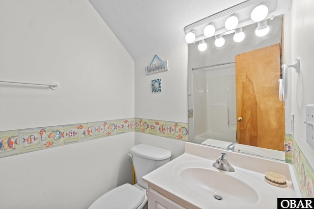 bathroom with a shower, toilet, vaulted ceiling, a textured ceiling, and vanity