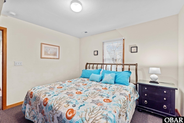 carpeted bedroom with visible vents and baseboards