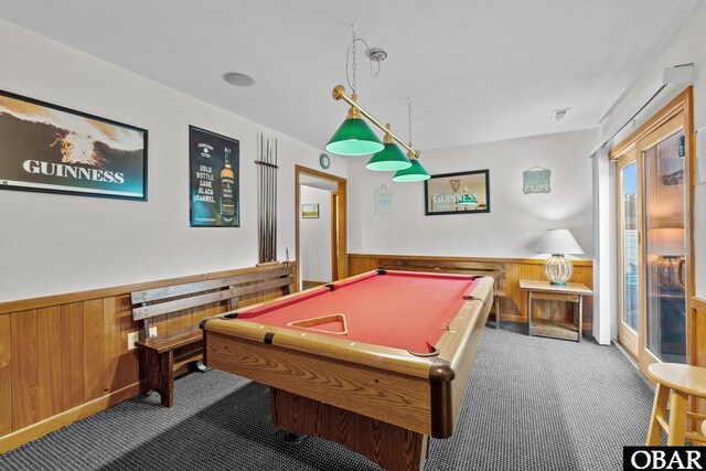 game room featuring dark carpet, wainscoting, and wooden walls