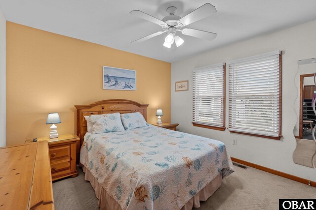 bedroom featuring baseboards, ceiling fan, and light colored carpet