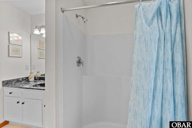 bathroom with curtained shower and vanity