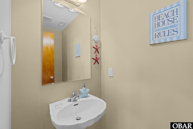 bathroom featuring visible vents and a sink