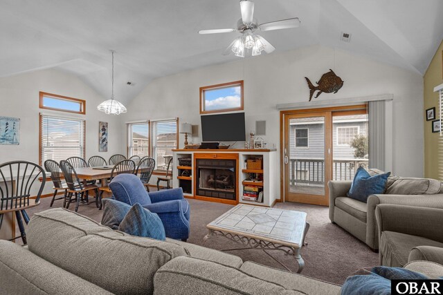 living room with light carpet, visible vents, a fireplace, high vaulted ceiling, and ceiling fan with notable chandelier