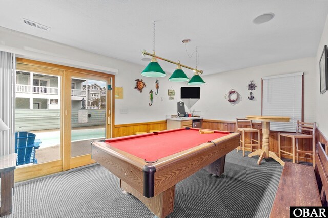 game room with a wainscoted wall, wooden walls, visible vents, and pool table