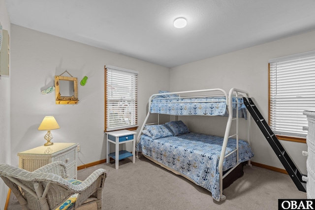 bedroom featuring carpet floors and baseboards