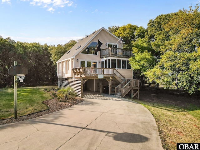 100 Tides Dr Lot 1, Duck, NC 27949 - view of front of home with stairway, concrete driveway, a front lawn, a balcony, and a carport