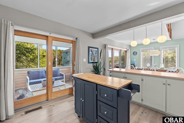 100 Tides Dr Lot 1, Duck, NC 27949 - kitchen featuring beamed ceiling, a center island, light wood finished floors, white cabinets, and butcher block countertops