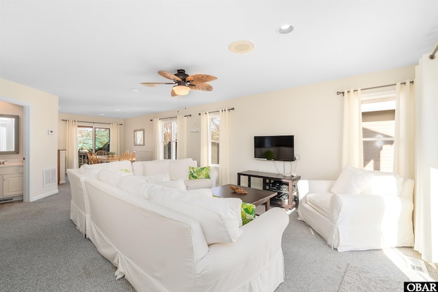 carpeted living room with a ceiling fan, recessed lighting, and visible vents