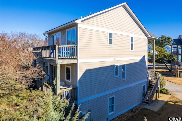 view of home's exterior with a balcony and stairs