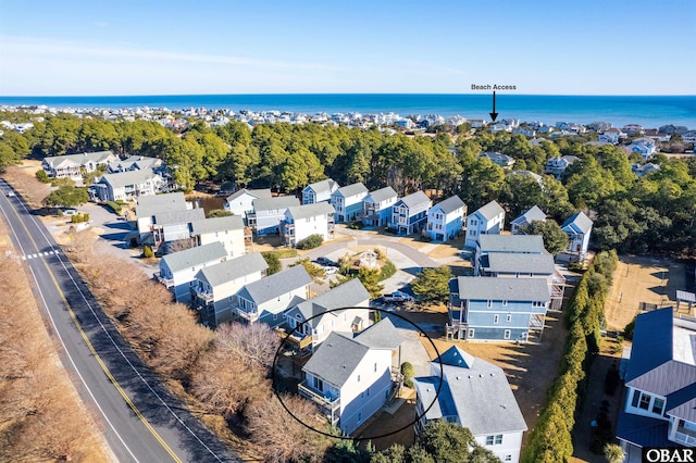 drone / aerial view featuring a water view and a residential view