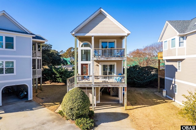 raised beach house featuring a carport and driveway