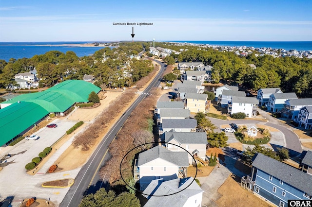 drone / aerial view featuring a residential view and a water view