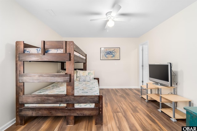 stairway with ceiling fan, baseboards, and wood finished floors