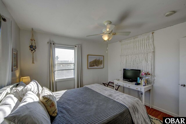 bedroom featuring ceiling fan, wood finished floors, and baseboards