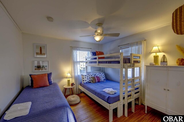 bedroom featuring ceiling fan, crown molding, and wood finished floors