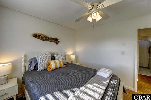 bedroom featuring light wood-type flooring, ceiling fan, and baseboards