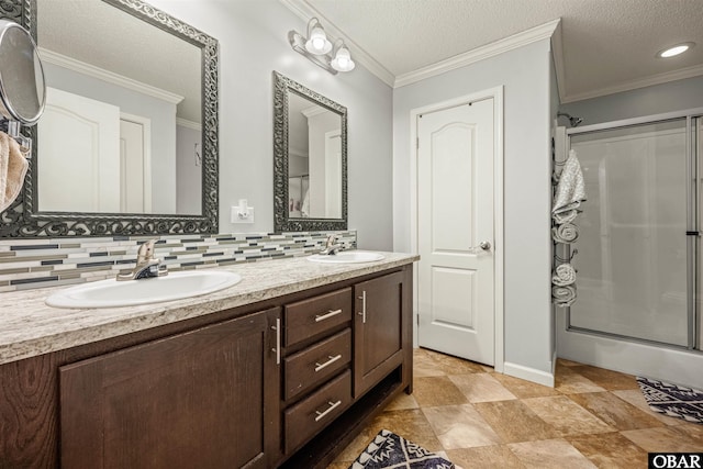 bathroom featuring tasteful backsplash, crown molding, and a sink