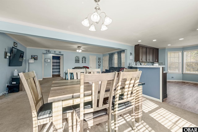 dining area featuring light carpet and crown molding