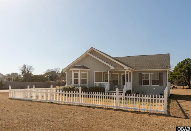 view of front of property featuring a porch and a fenced front yard