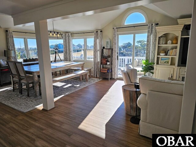 dining area featuring lofted ceiling and dark wood finished floors