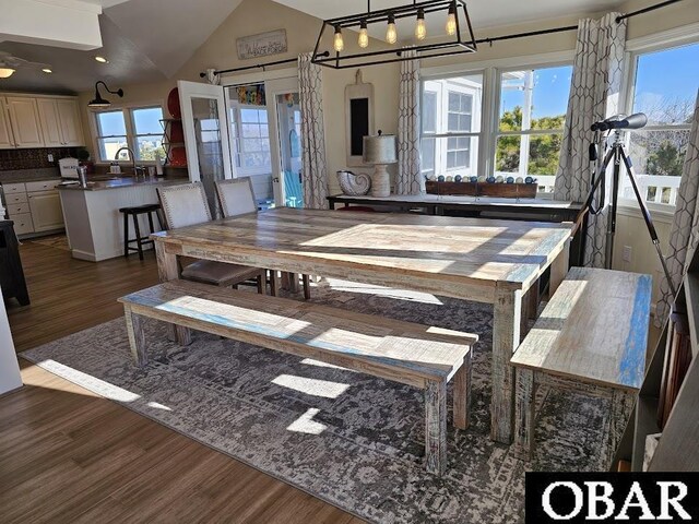 dining space with recessed lighting, dark wood-style flooring, and vaulted ceiling