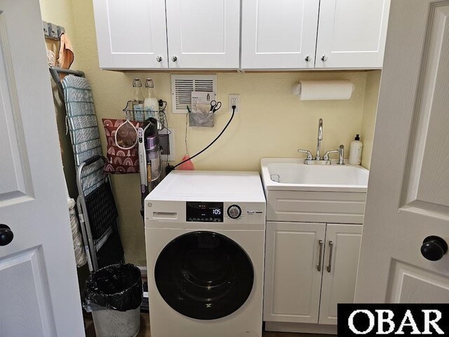 laundry room with cabinet space, washer / clothes dryer, and a sink