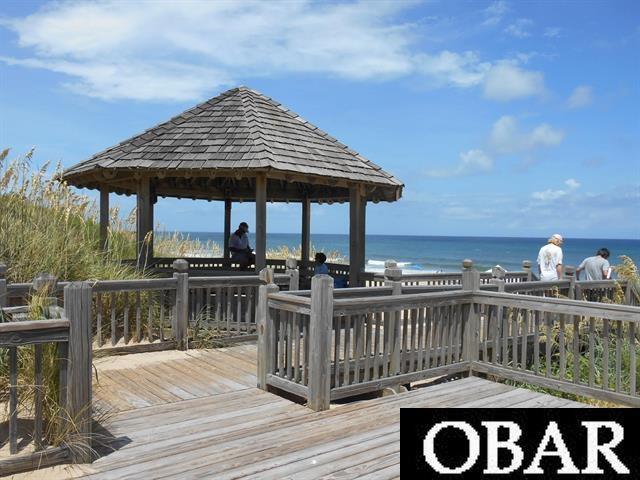 dock area featuring a deck with water view and a gazebo