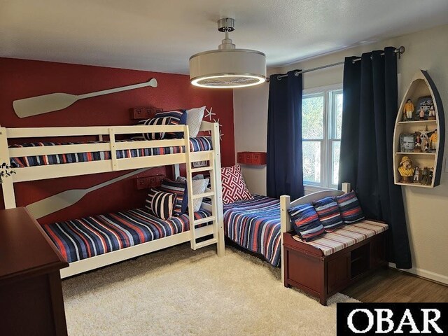 carpeted bedroom featuring baseboards