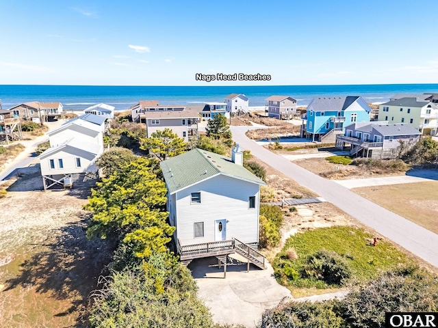 drone / aerial view featuring a water view and a residential view