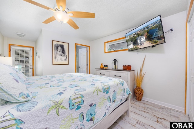 761 Bayberry Ct Lot 119, Corolla, NC 27927 - bedroom featuring light wood-style floors, baseboards, ceiling fan, and a textured ceiling