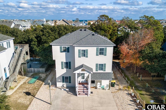 761 Bayberry Ct Lot 119, Corolla, NC 27927 - back of house featuring stairway, a shingled roof, and a residential view