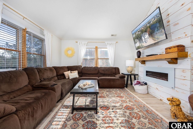 761 Bayberry Ct Lot 119, Corolla, NC 27927 - living room featuring wood finished floors and a glass covered fireplace