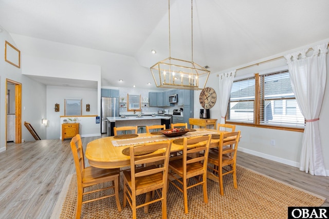 761 Bayberry Ct Lot 119, Corolla, NC 27927 - dining area featuring vaulted ceiling, light wood finished floors, a chandelier, baseboards, and recessed lighting