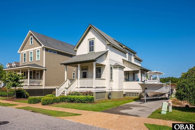 view of front of home with a shingled roof, stairway, a porch, and board and batten siding