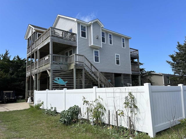 exterior space featuring fence private yard and a balcony