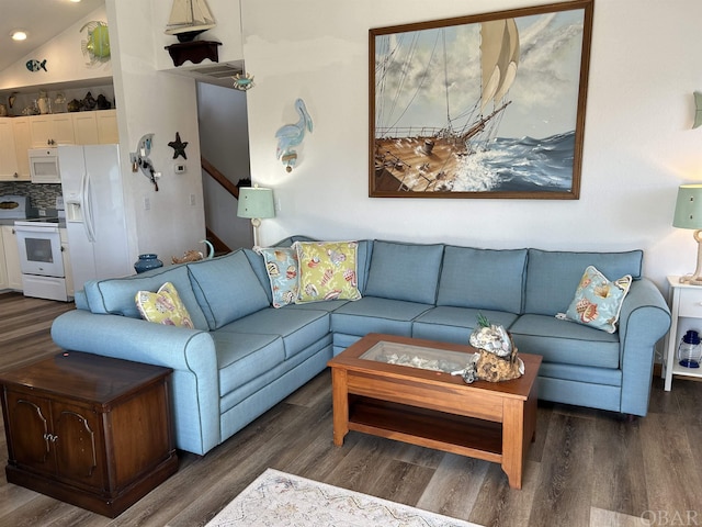 living area with dark wood-type flooring and vaulted ceiling