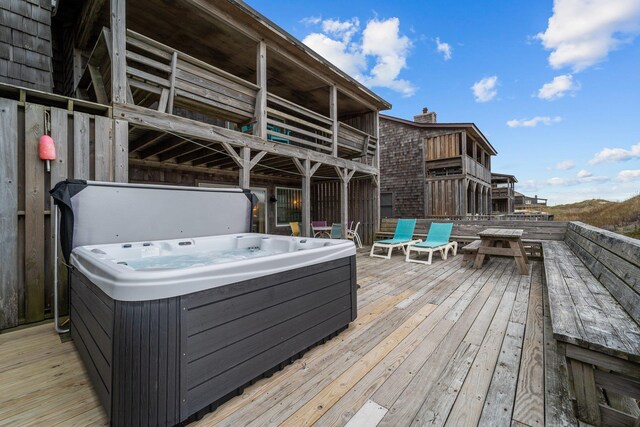 wooden deck featuring a hot tub