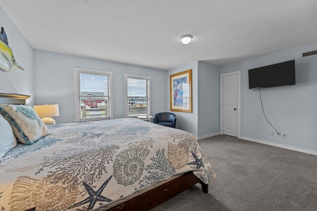 carpeted bedroom with visible vents and baseboards