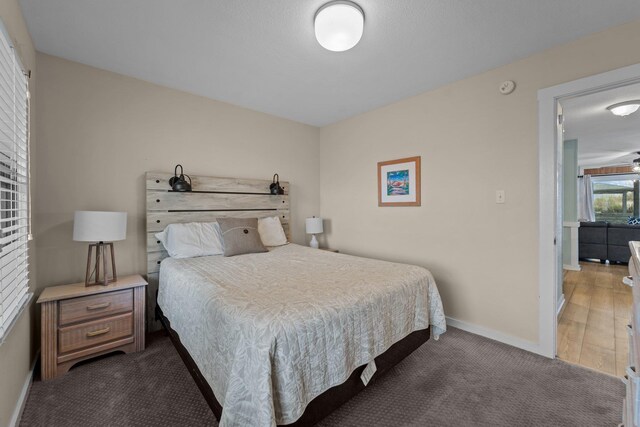 carpeted bedroom featuring baseboards