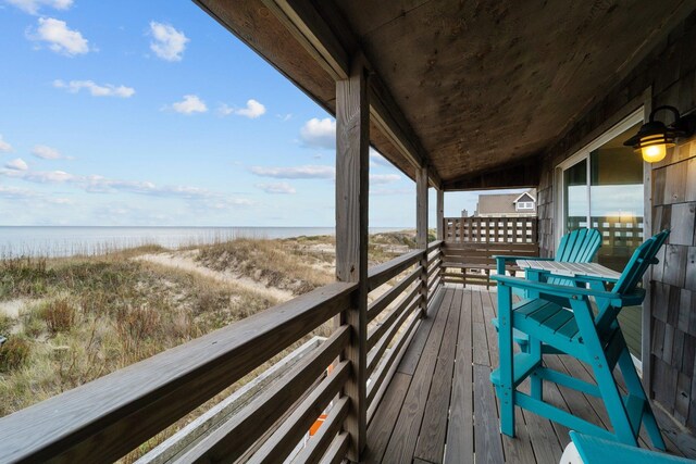 wooden terrace featuring a water view