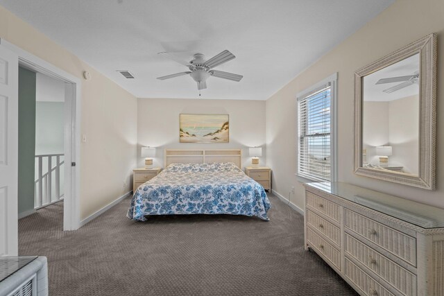 bedroom featuring ceiling fan, dark colored carpet, visible vents, and baseboards